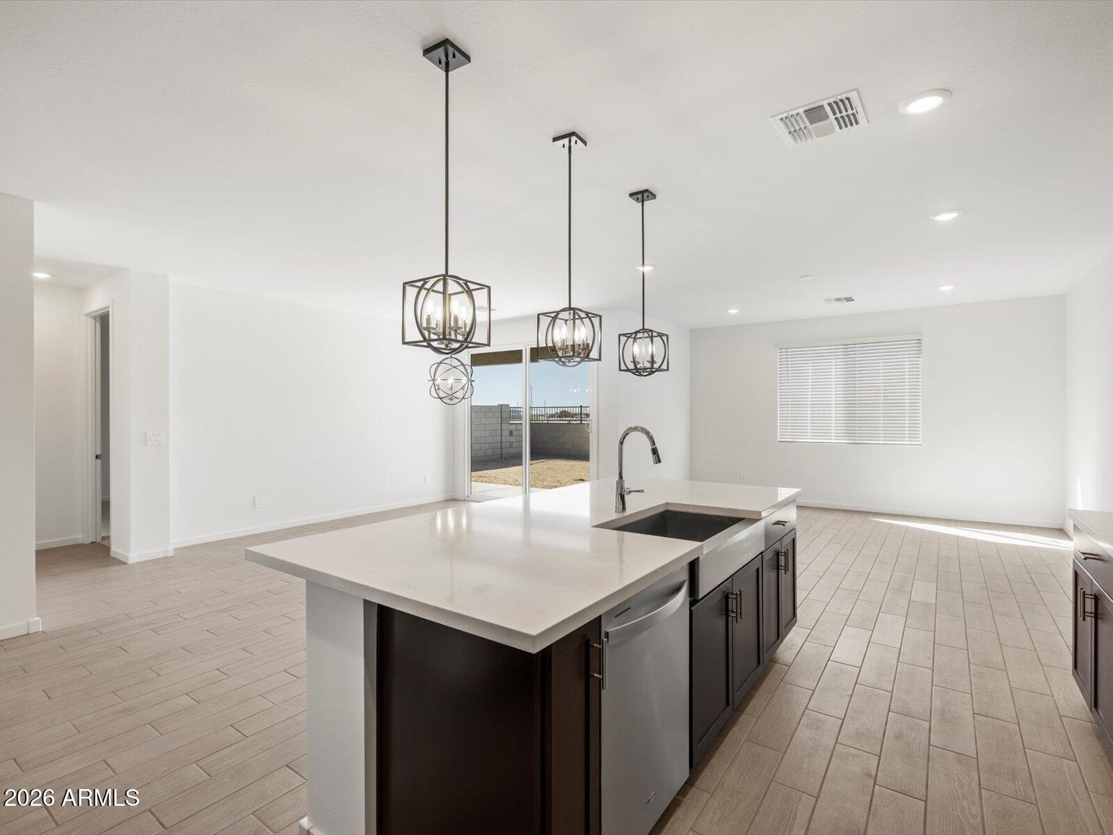 2380 Grenache Road San Tan Valley, AZ 85143 - Photo 23 of 78 a kitchen with stainless steel appliances granite countertop a sink a counter space and cabinets