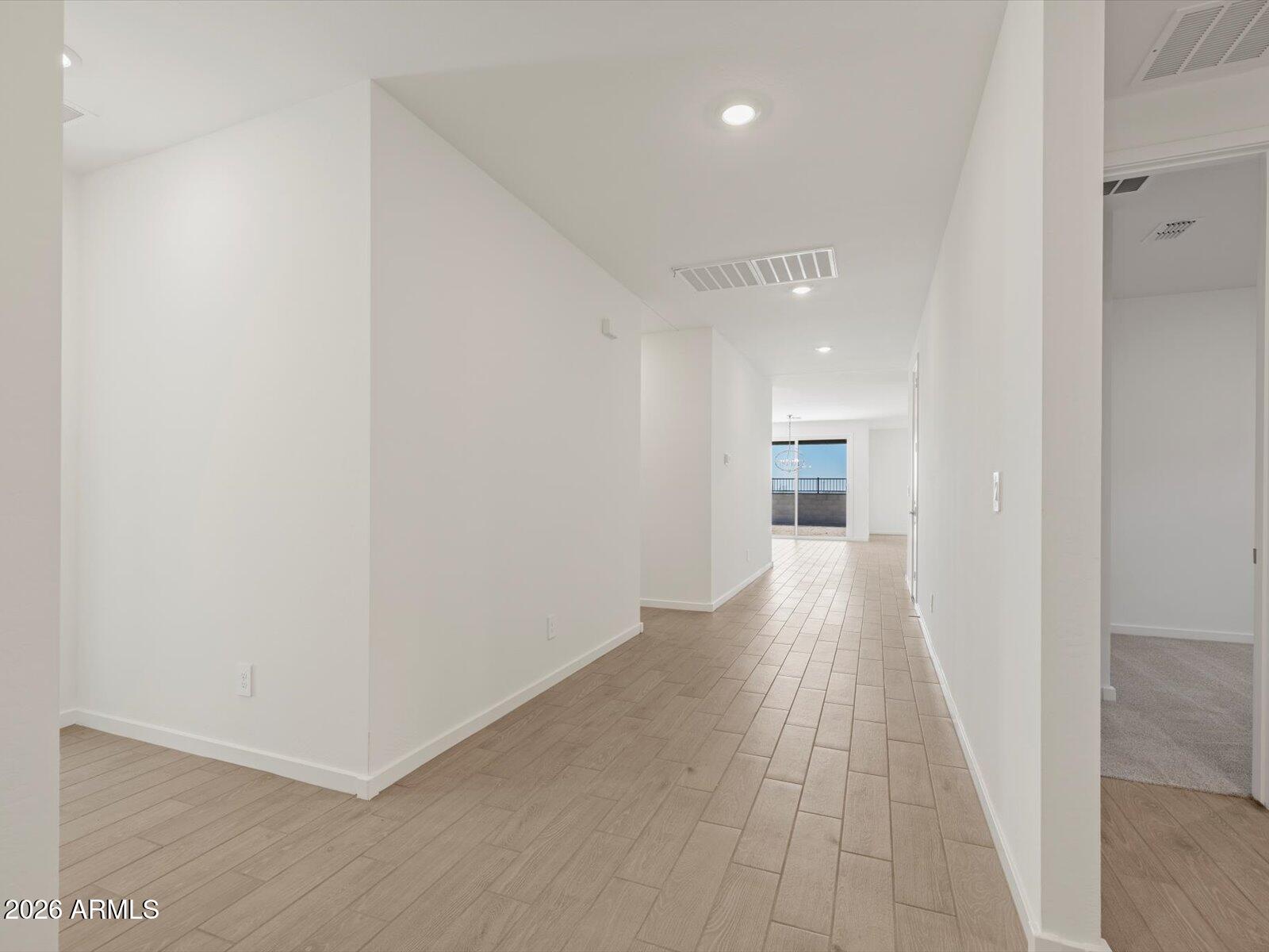 2380 Grenache Road San Tan Valley, AZ 85143 - Photo 2 of 78 a view of a hallway with wooden floor and a bathroom