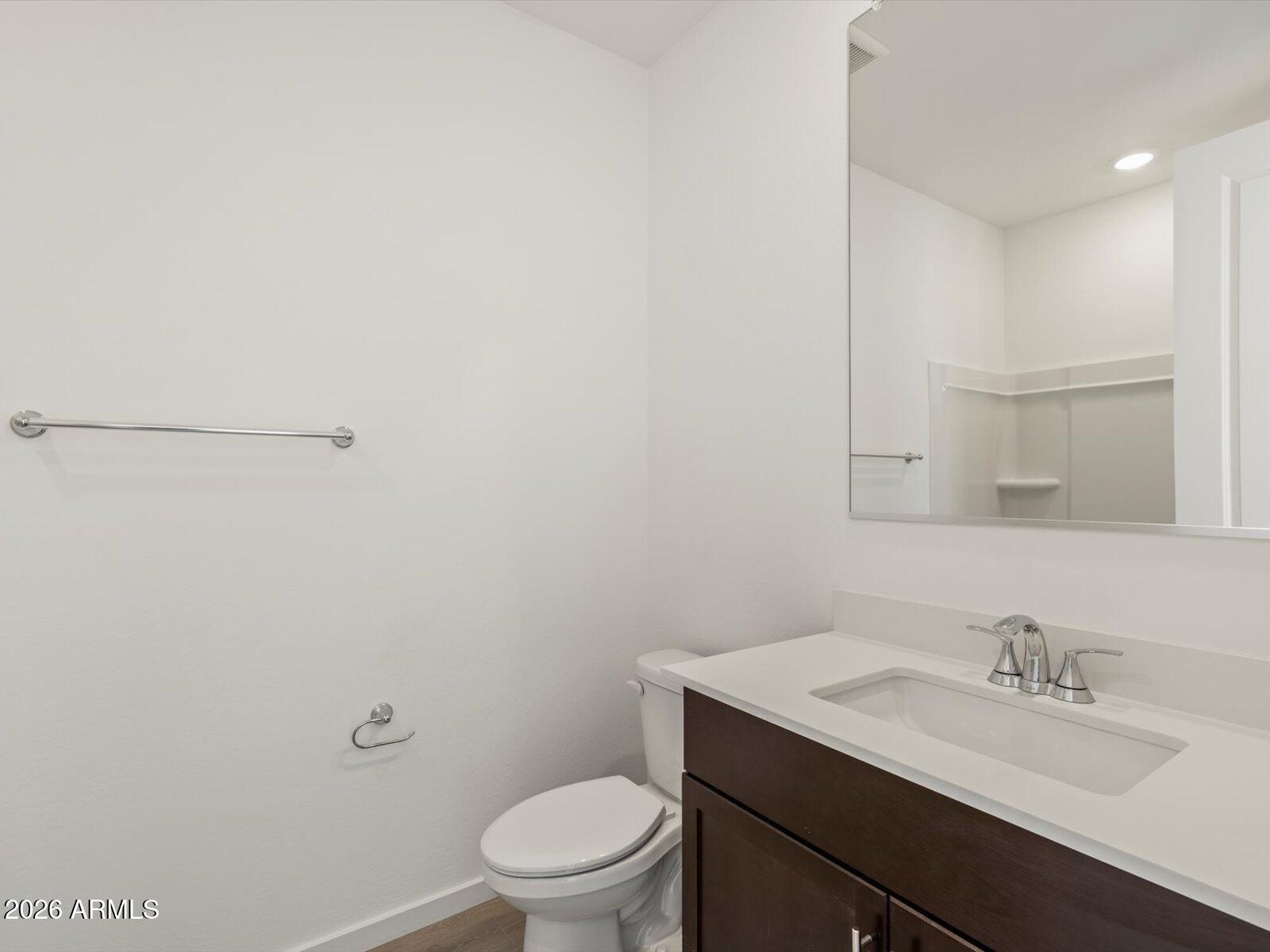 2380 Grenache Road San Tan Valley, AZ 85143 - Photo 4 of 78 a bathroom with a granite countertop sink mirror vanity and toilet