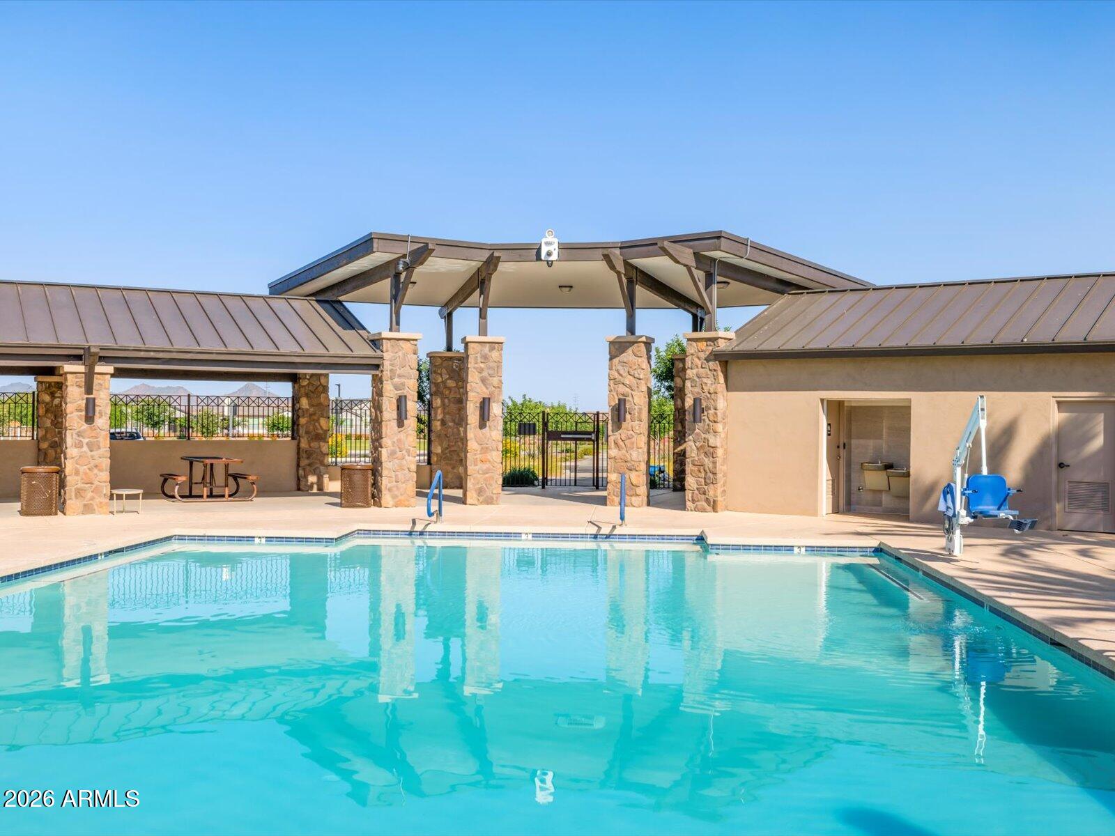 2380 Grenache Road San Tan Valley, AZ 85143 - Photo 59 of 78 a view of a house with floor to ceiling windows and a yard