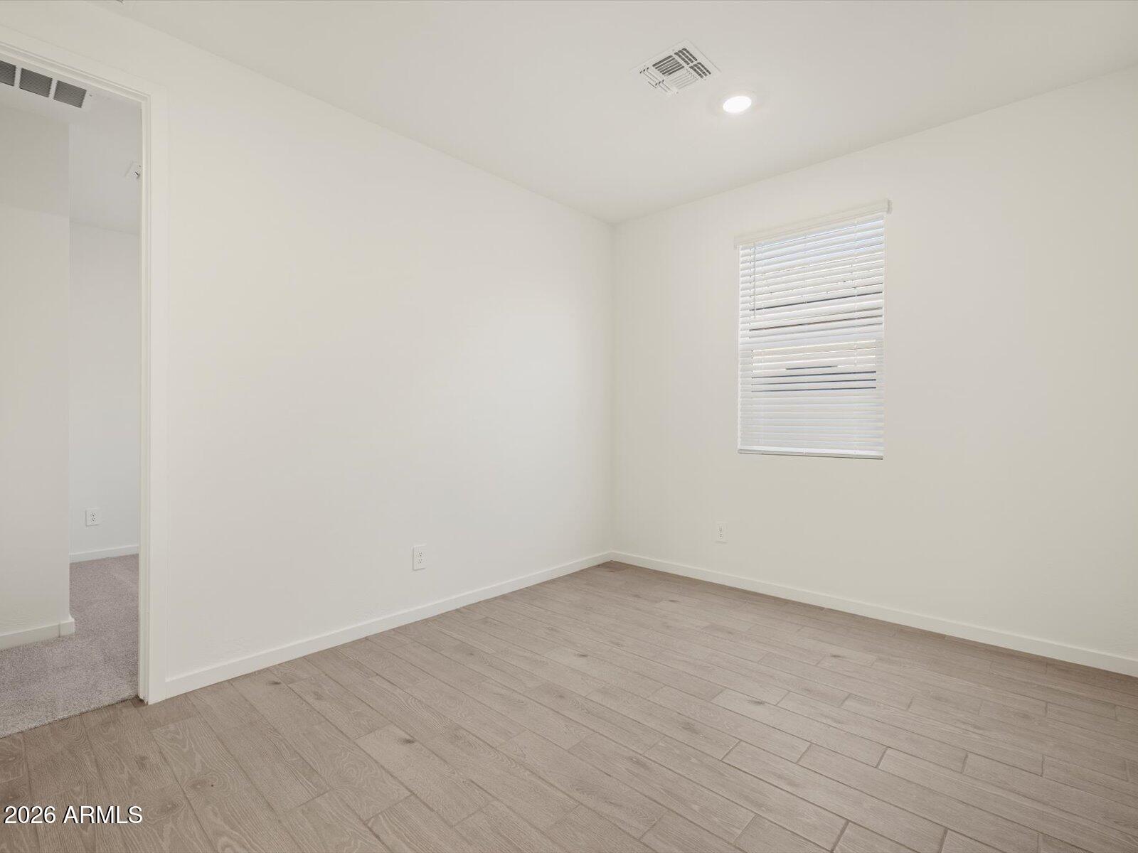 2380 Grenache Road San Tan Valley, AZ 85143 - Photo 7 of 78 a view of an empty room with a window