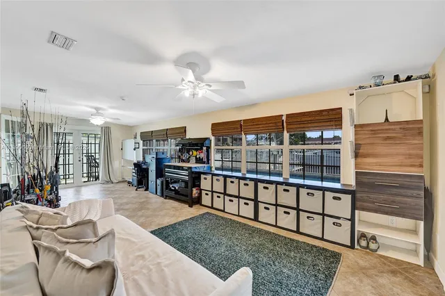 a living room with furniture a view of dining room and wooden floor