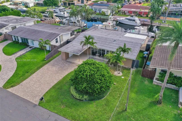 an aerial view of a house with garden space and street view