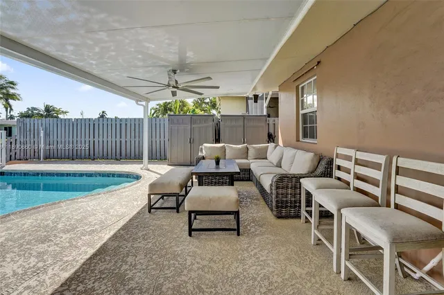 a balcony with furniture and a potted plant