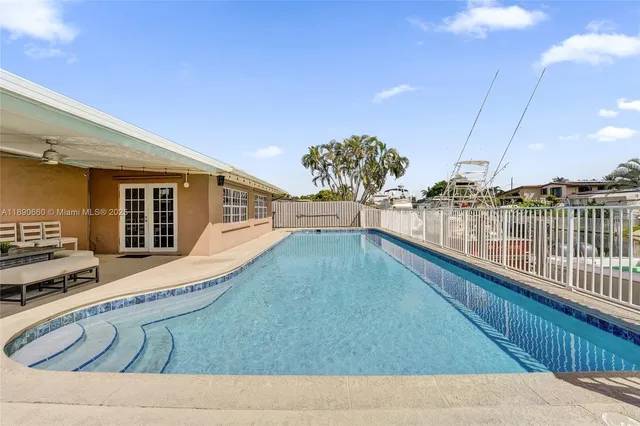 a view of swimming pool with outdoor seating