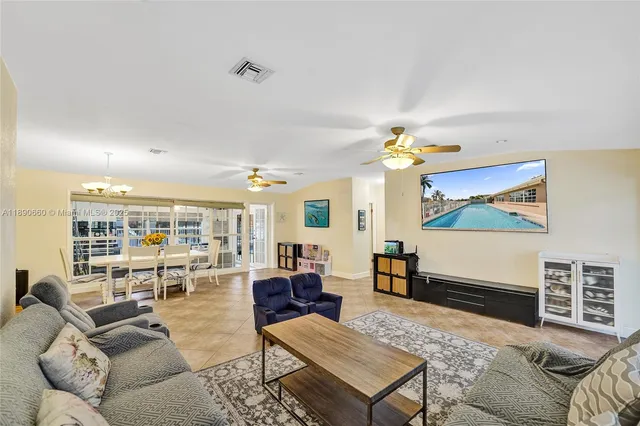a living room with furniture a rug and a chandelier