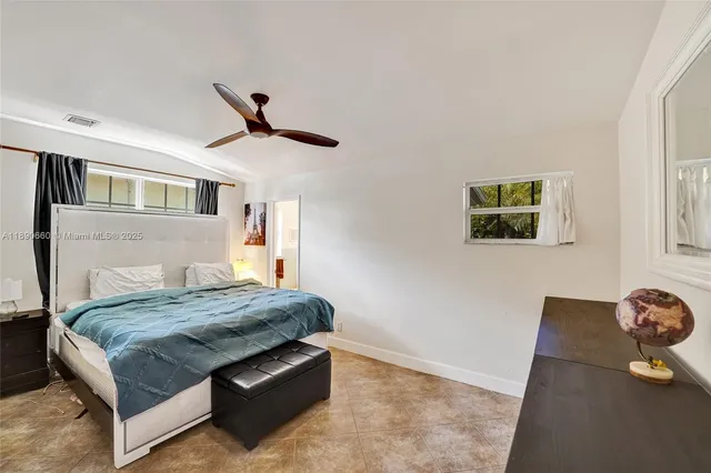 a living room with granite countertop furniture and a wooden floor
