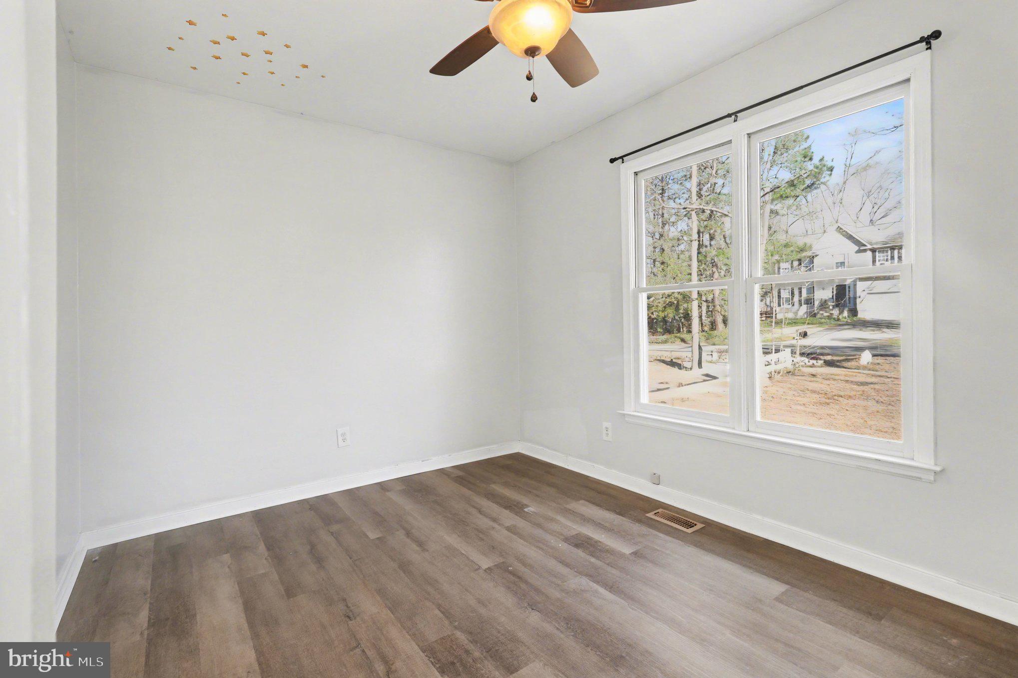 426 Durham Drive Ruther Glen, VA 22546 - Photo 18 of 33 wooden floor in an empty room with a window