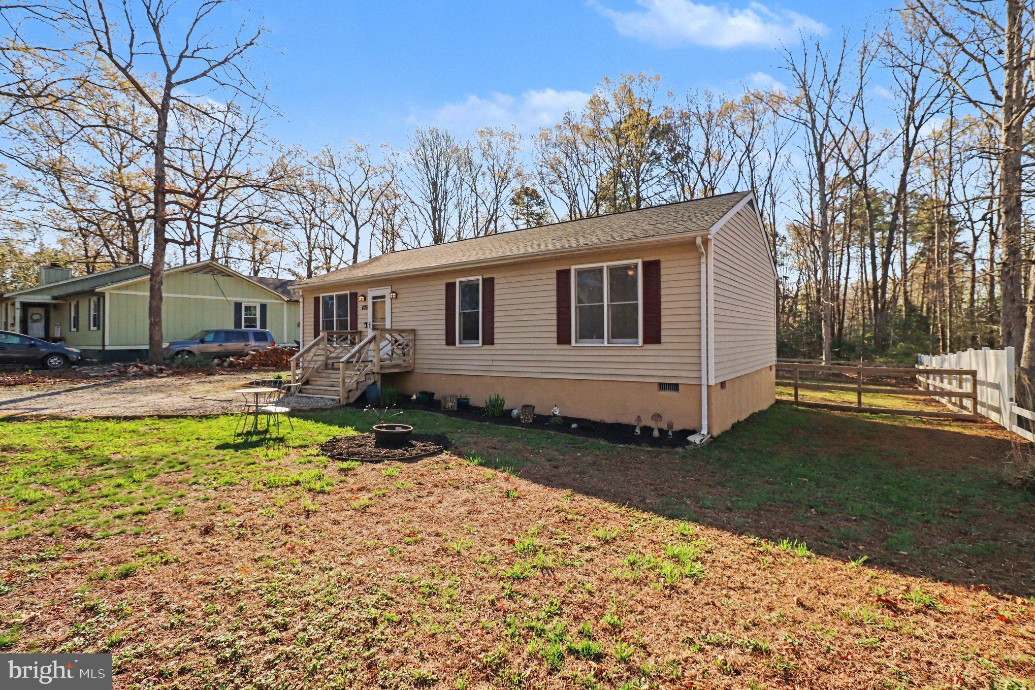 426 Durham Drive Ruther Glen, VA 22546 - Photo 2 of 33 a backyard of a house with yard and outdoor seating