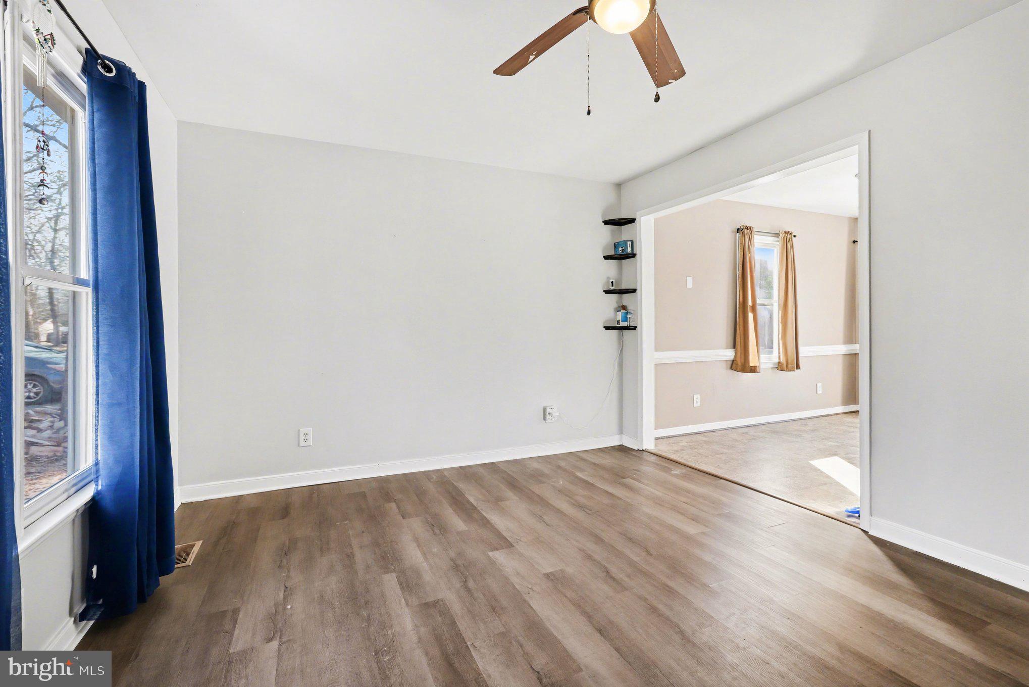 426 Durham Drive Ruther Glen, VA 22546 - Photo 6 of 33 an empty room with wooden floor and windows