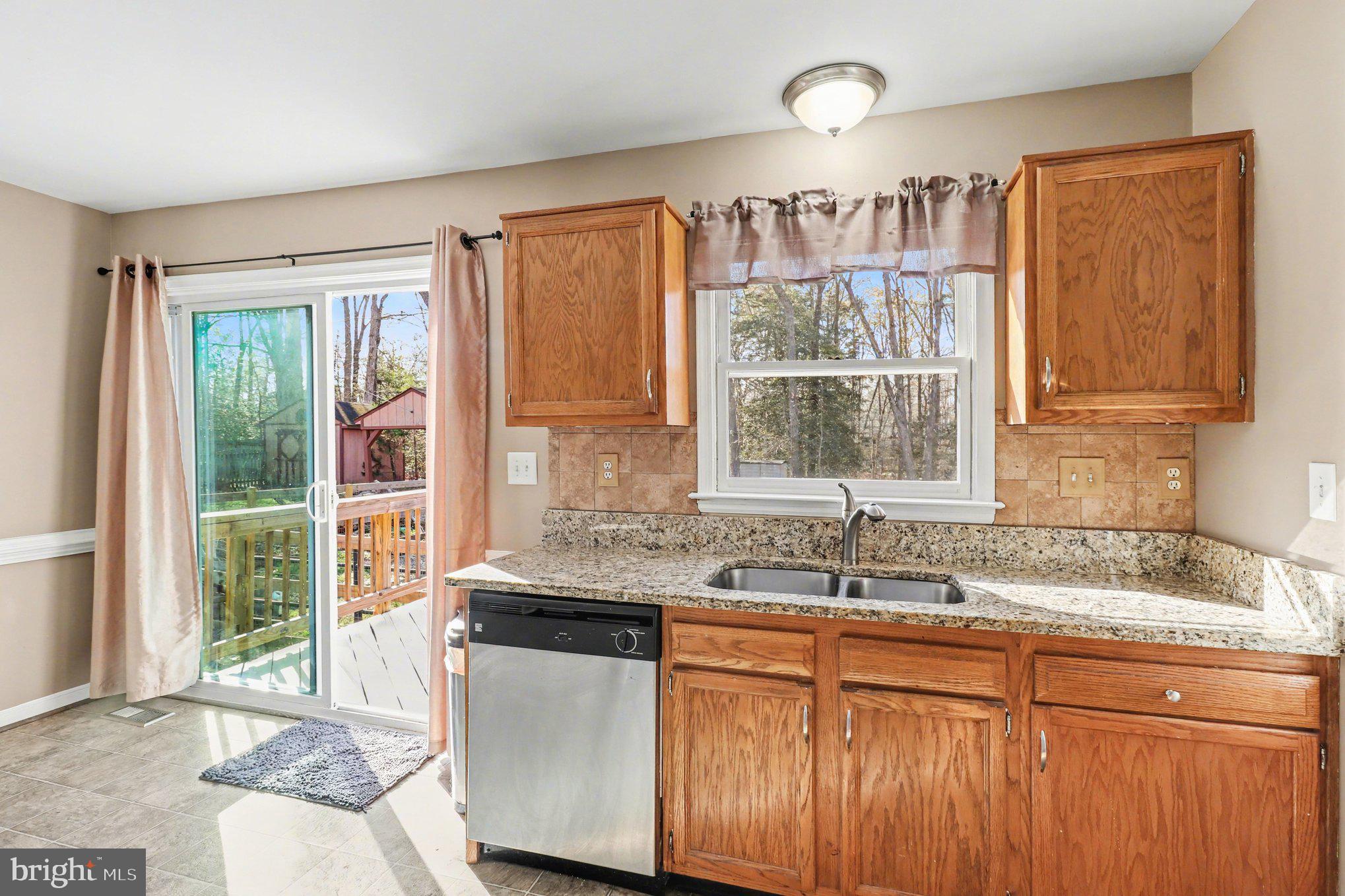 426 Durham Drive Ruther Glen, VA 22546 - Photo 8 of 33 a kitchen with granite countertop a sink and a window