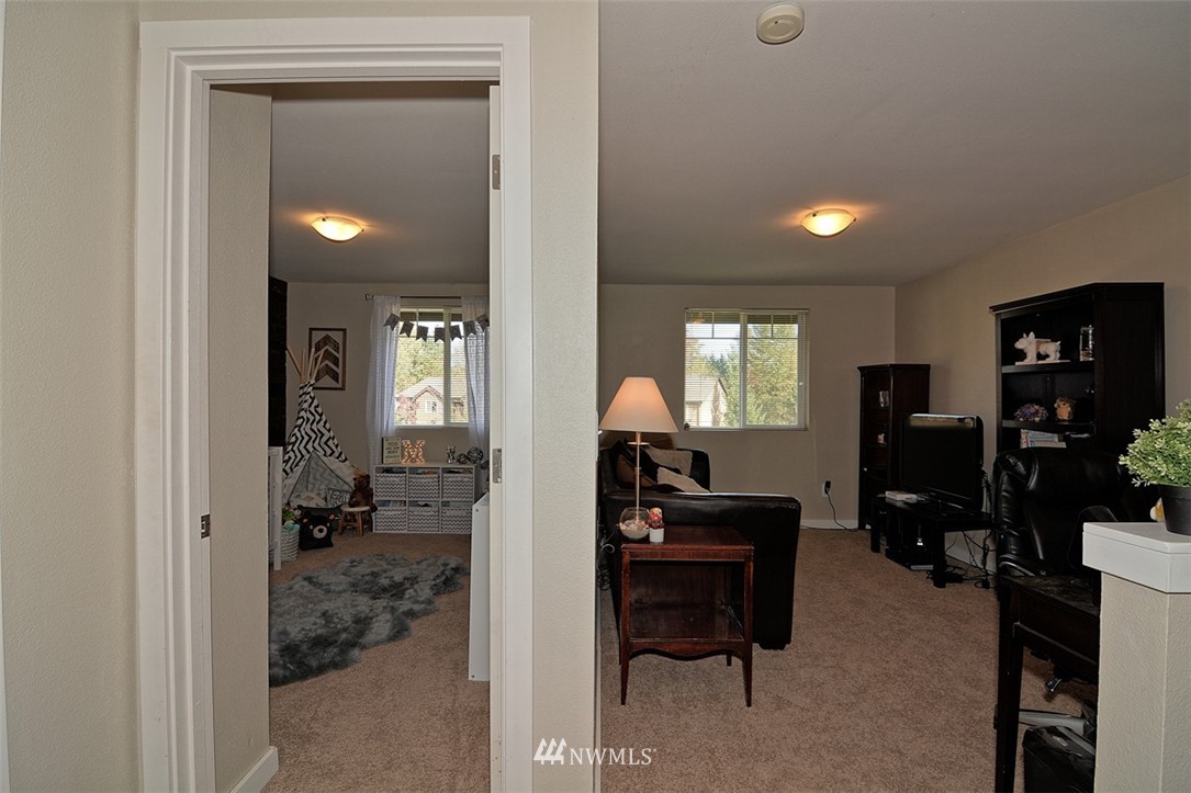 18930 Bothell Everett Highway, Unit M105 Bothell, WA 98012 - Photo 14 of 19 a view of a livingroom with furniture and windows