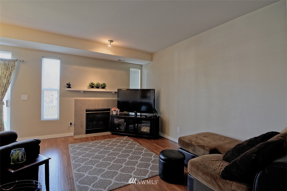 18930 Bothell Everett Highway, Unit M105 Bothell, WA 98012 - Photo 3 of 19 a bedroom with furniture and a fireplace