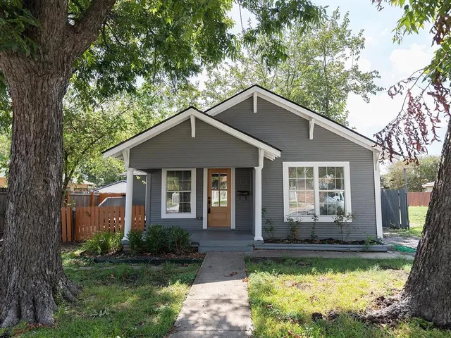 a front view of a house with a yard table and chairs