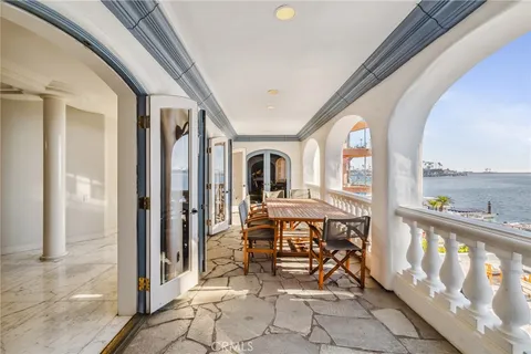 a view of a dining room and livingroom with furniture wooden floor a chandelier