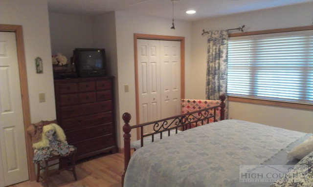 706 Pine Ridge Road Beech Mountain, NC 28604 - Photo 14 of 16 a bedroom with furniture and a window