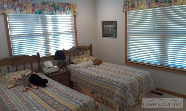 706 Pine Ridge Road Beech Mountain, NC 28604 - Photo 4 of 16 a bedroom with a bed and two windows