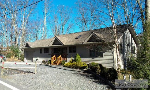 706 Pine Ridge Road Beech Mountain, NC 28604 - Photo 7 of 16 a front view of a house with a yard