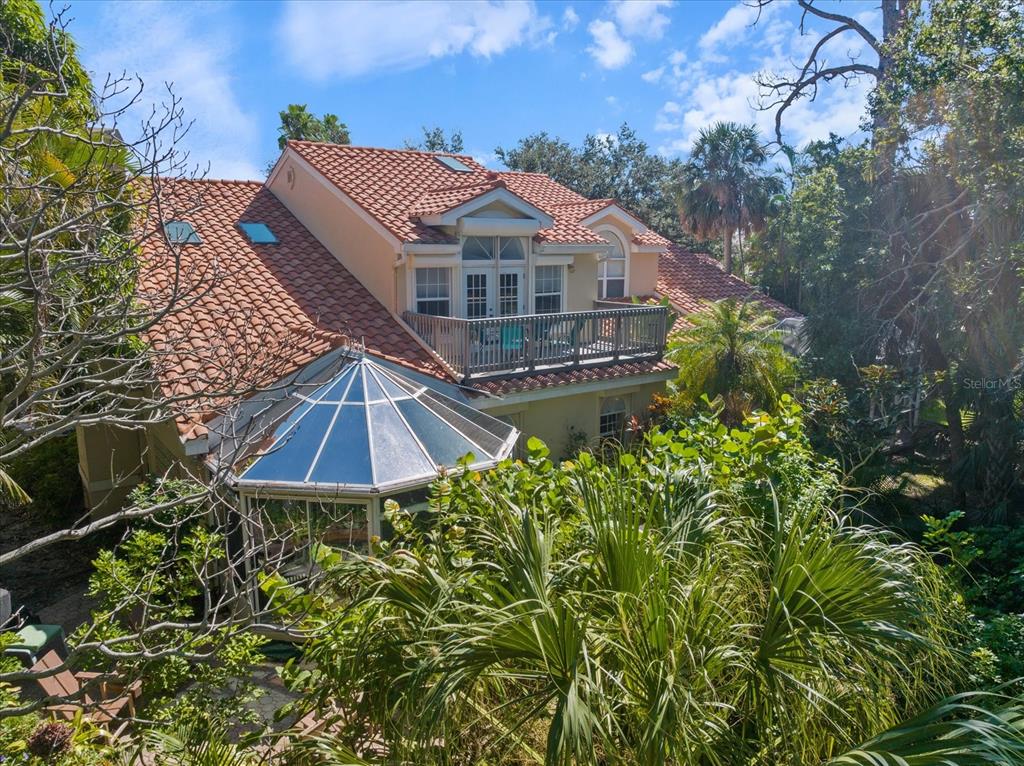 447 Oak Point Road Osprey, FL 34229 - Photo 12 of 99 a front view of a house with a yard and balcony