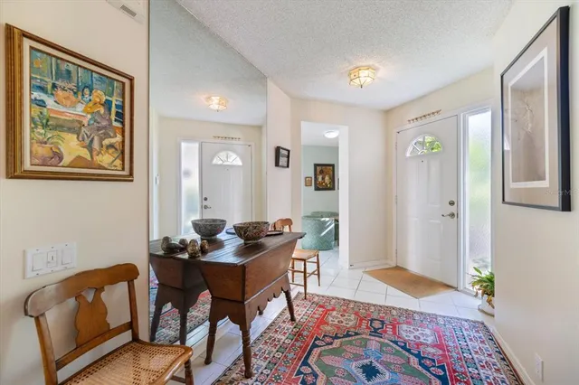 a spacious bedroom with a bed a table window and couch