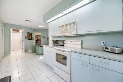 a spacious bedroom with a bed a table and chair