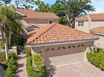 an aerial view of ocean and residential houses with outdoor space