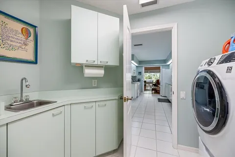 a living room with furniture a dining table and chairs with kitchen view