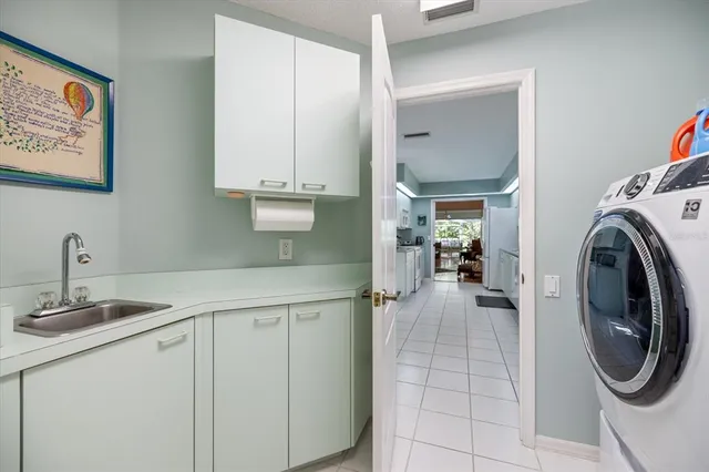 a living room with furniture a dining table and chairs with kitchen view