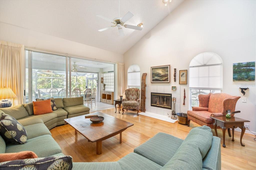 447 Oak Point Road Osprey, FL 34229 - Photo 28 of 99 a living room with furniture fireplace and a large window