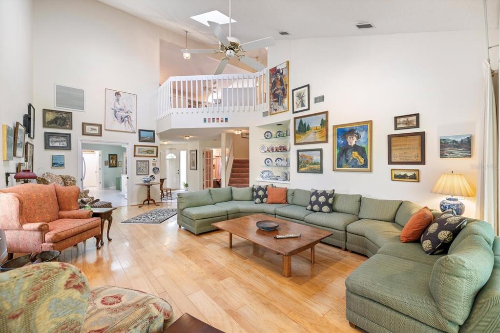 447 Oak Point Road Osprey, FL 34229 - Photo 29 of 99 a living room with furniture or couch and a chandelier