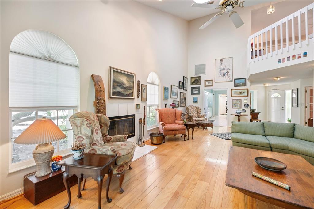 447 Oak Point Road Osprey, FL 34229 - Photo 30 of 99 a living room with furniture and a fireplace