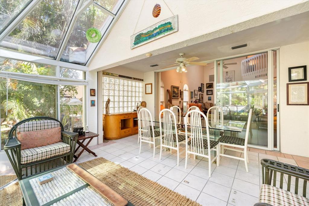 447 Oak Point Road Osprey, FL 34229 - Photo 34 of 99 a dining room with furniture a chandelier and wooden floor