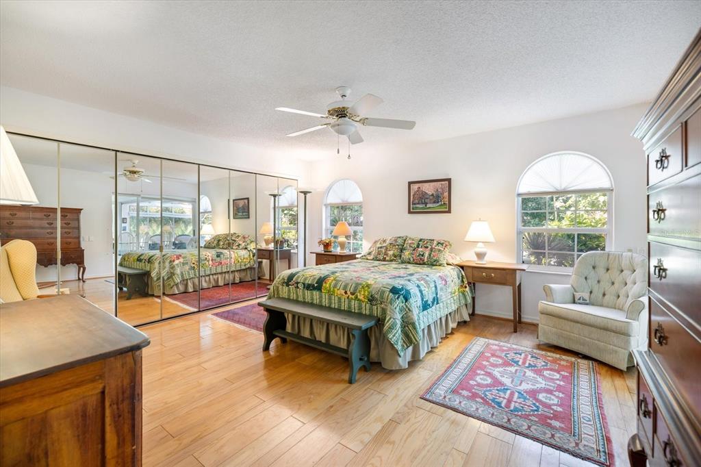 447 Oak Point Road Osprey, FL 34229 - Photo 37 of 99 a spacious bedroom with a bed a table window and couch