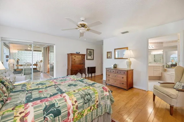 a view of a backyard with wooden fence and large trees