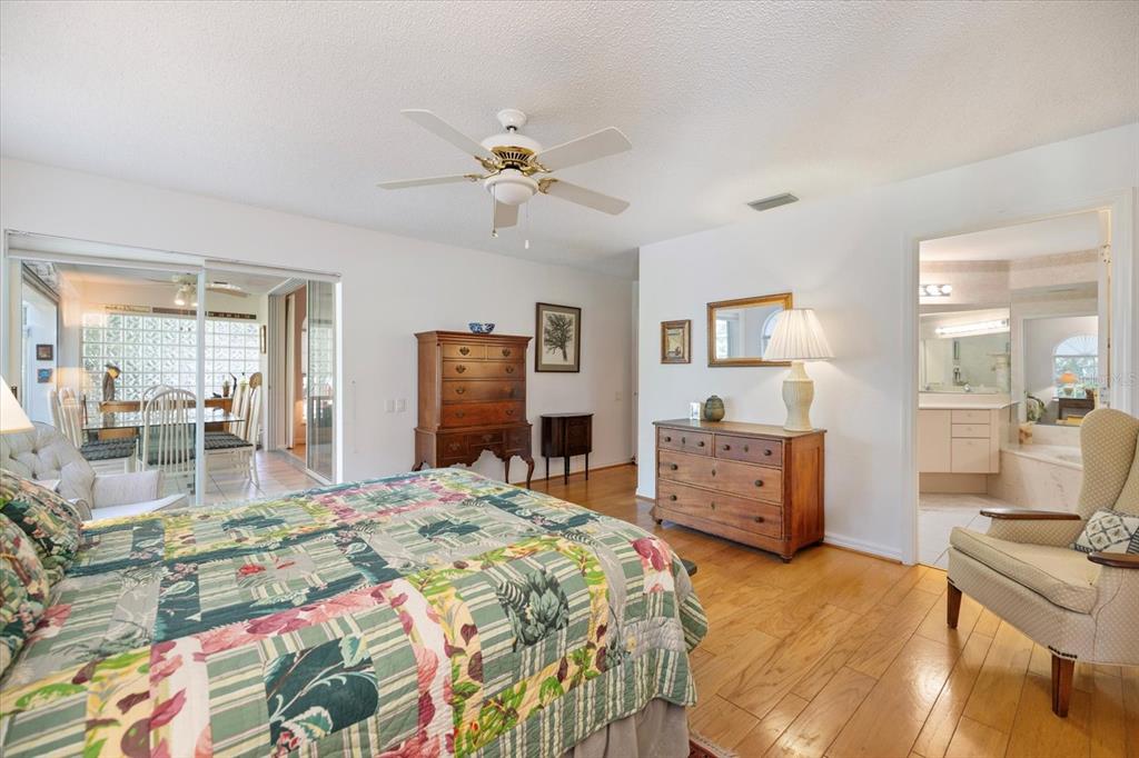 447 Oak Point Road Osprey, FL 34229 - Photo 38 of 99 a bedroom with a bed and wooden floor