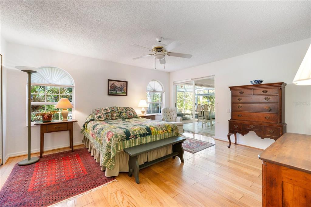 447 Oak Point Road Osprey, FL 34229 - Photo 39 of 99 a spacious bedroom with a bed a table and chair
