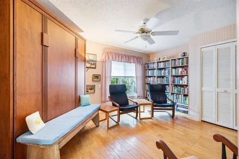 a living room with furniture fireplace and a large window