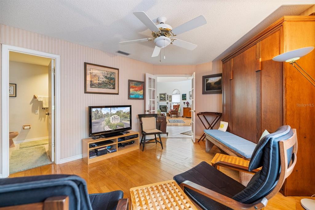 447 Oak Point Road Osprey, FL 34229 - Photo 46 of 99 a living room with furniture a flat screen tv and a window