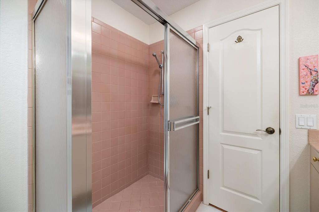447 Oak Point Road Osprey, FL 34229 - Photo 50 of 99 a bathroom with a glass shower door and a shower