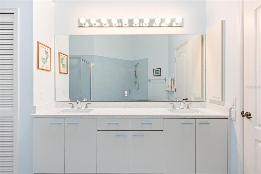 447 Oak Point Road Osprey, FL 34229 - Photo 59 of 99 a bathroom with a sink vanity granite and a mirror