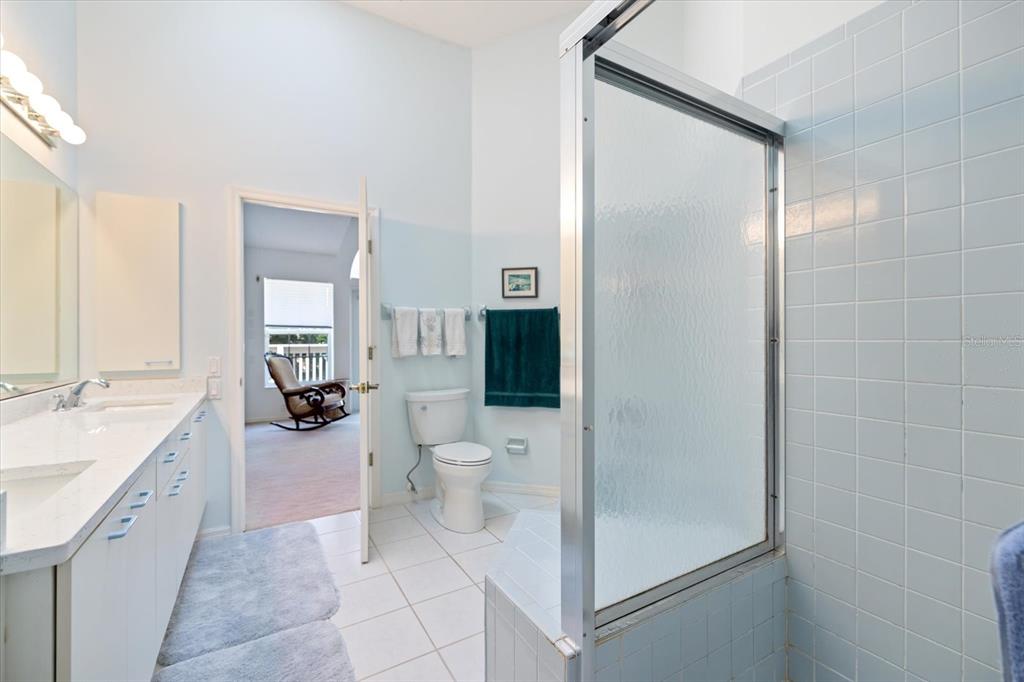 447 Oak Point Road Osprey, FL 34229 - Photo 60 of 99 a spacious bathroom with a double vanity sink a toilet and a shower