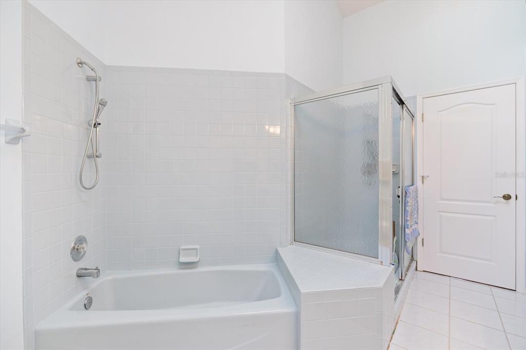 447 Oak Point Road Osprey, FL 34229 - Photo 61 of 99 a bathroom with a bathtub and a shower