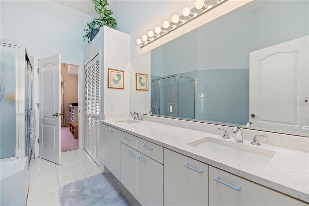 447 Oak Point Road Osprey, FL 34229 - Photo 62 of 99 a spacious bathroom with a double vanity sink mirror and shower