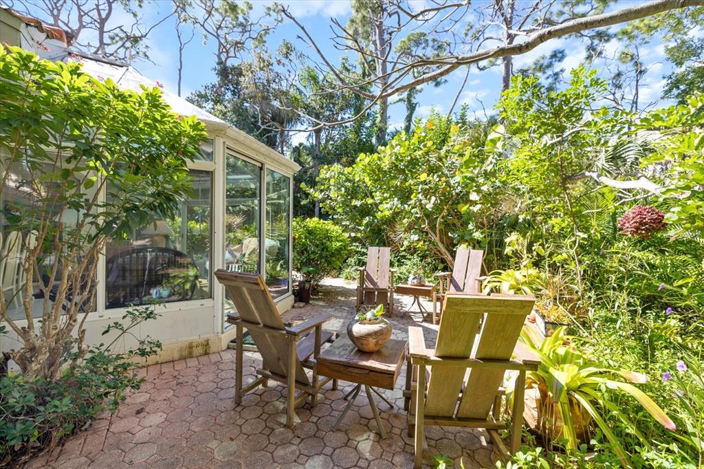 447 Oak Point Road Osprey, FL 34229 - Photo 66 of 99 a view of a patio with table and chairs and potted plants