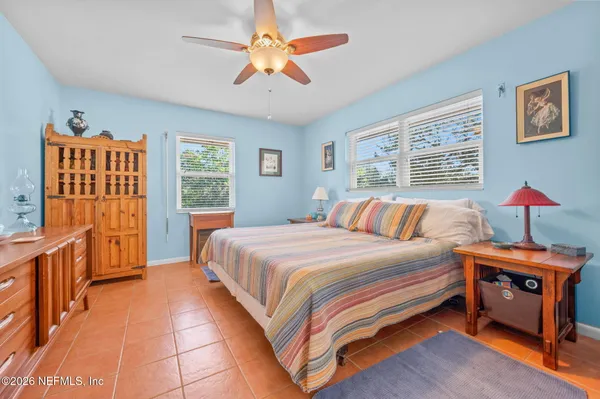a living room with furniture a large window and a chandelier