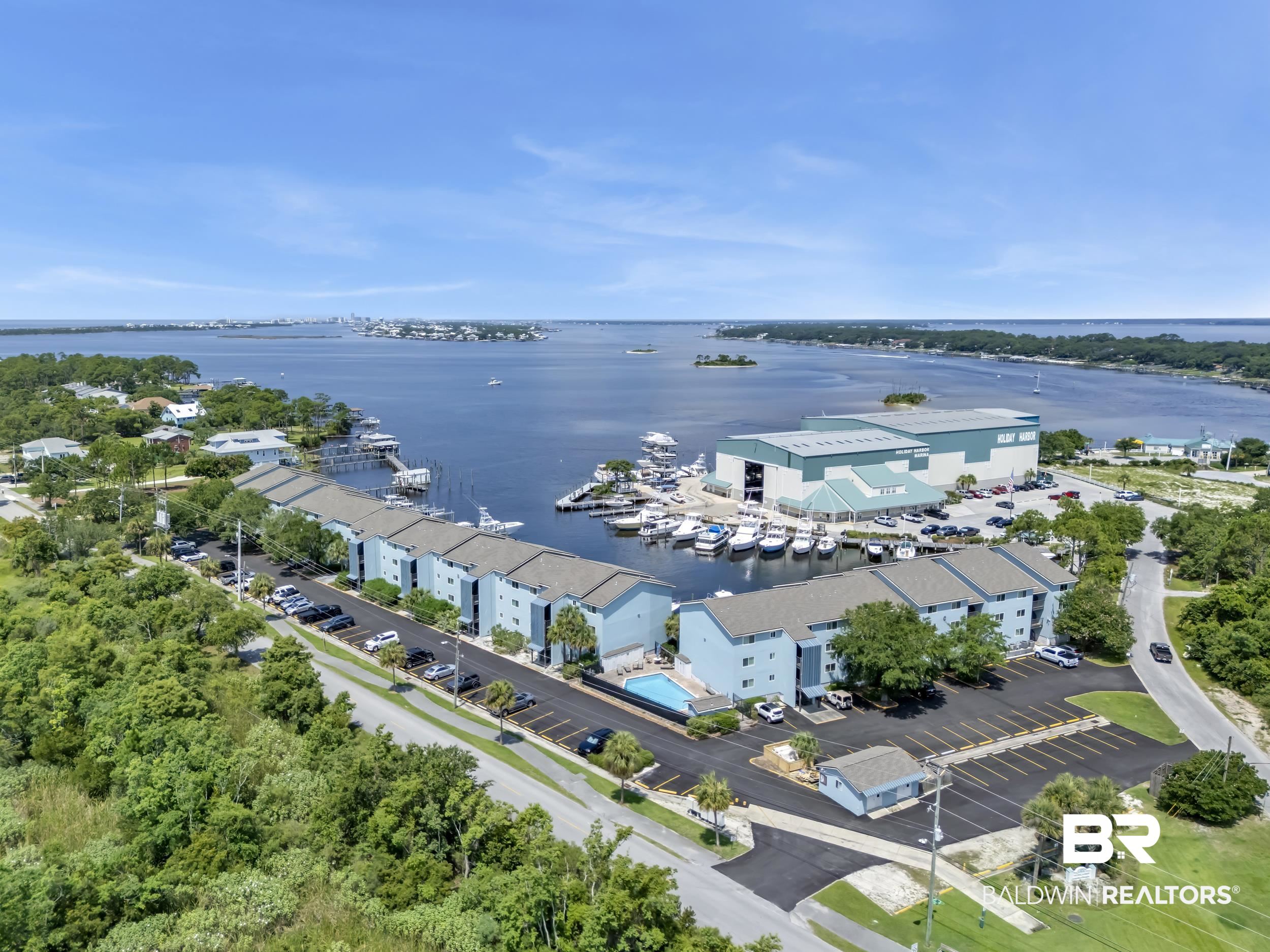 14100 River Road, Unit 211 Pensacola, FL 32507 - Photo 52 of 56 Waterfront community featuring multiple buildings with private balconies, ample parking, a swimming pool, and direct marina access