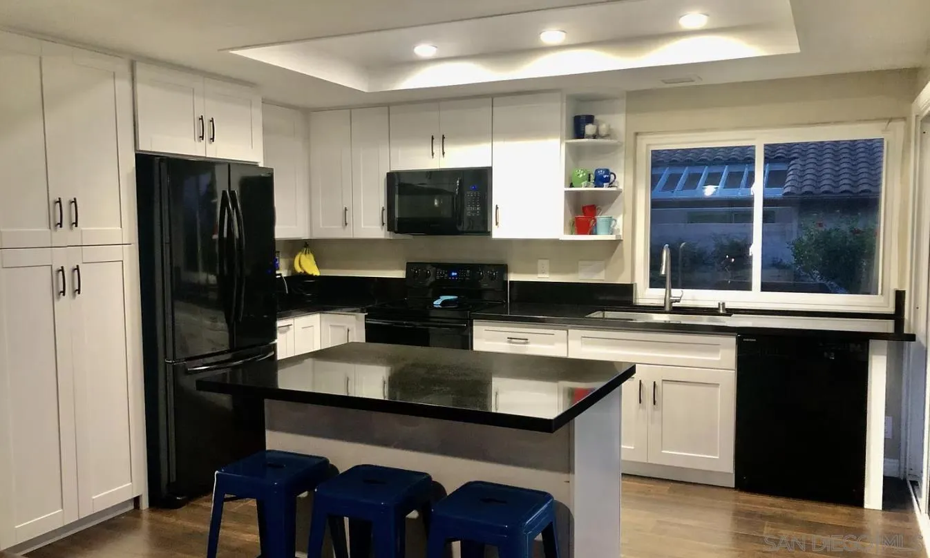 660 San Mario Drive Solana Beach, CA 92075 - Photo 5 of 25 a kitchen with a sink cabinets and refrigerator
