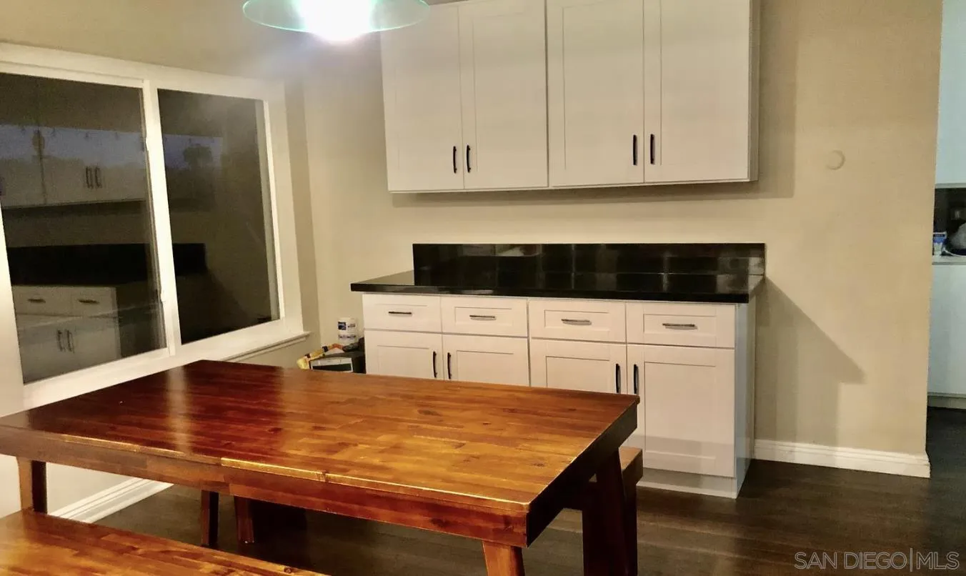 660 San Mario Drive Solana Beach, CA 92075 - Photo 7 of 25 a kitchen with stainless steel appliances cabinets and wooden floor