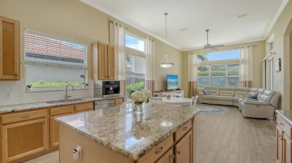 7717 US Open Loop Lakewood Ranch, FL 34202 - Photo 12 of 95 a kitchen with sink refrigerator and window