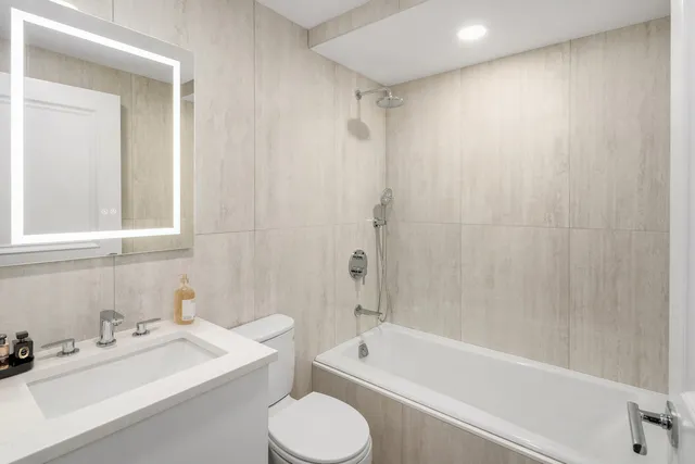 a living room with furniture a window and potted plants